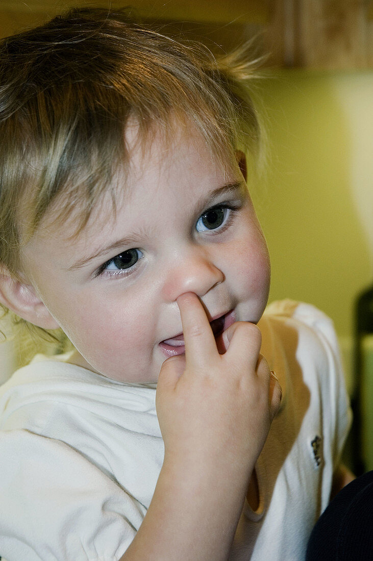 Toddler with finger in nose