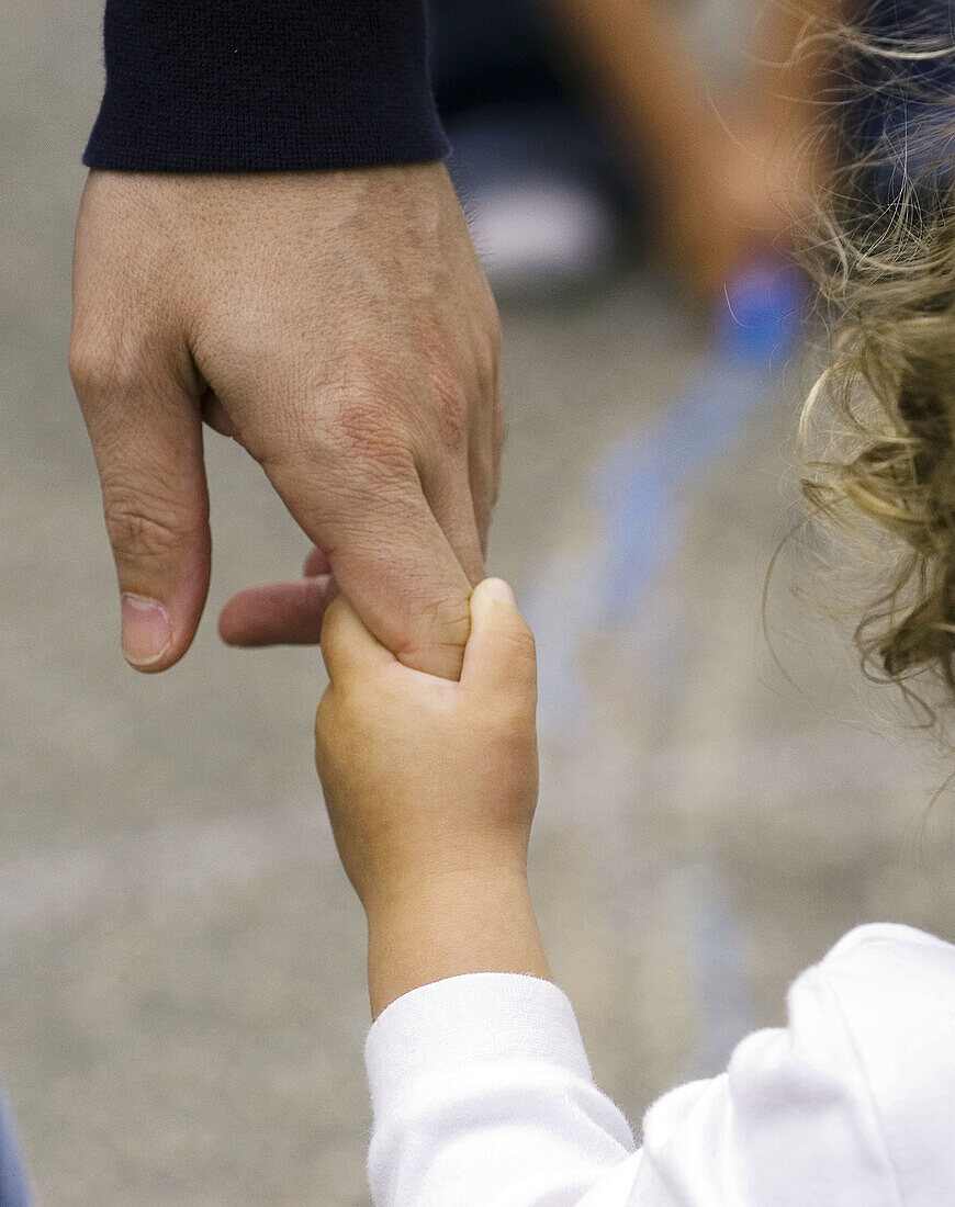 Toddler holding father s hand