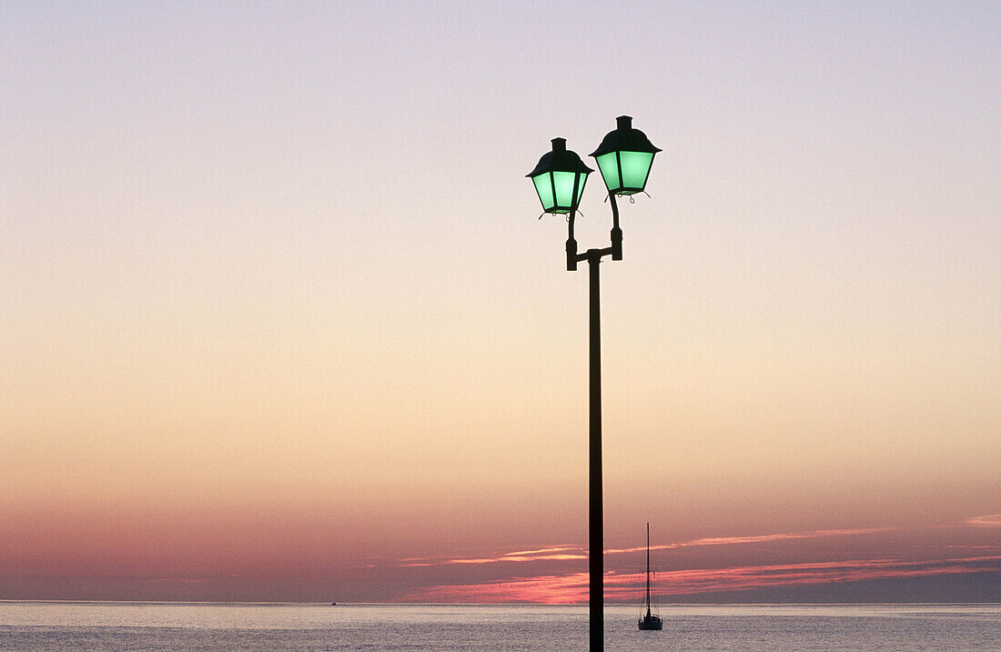 Ocean, lightposts, sun.