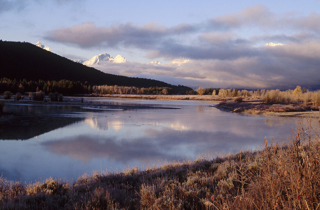 Lake and Grand Teton Mountains, USA , mist , clouds and blue sky