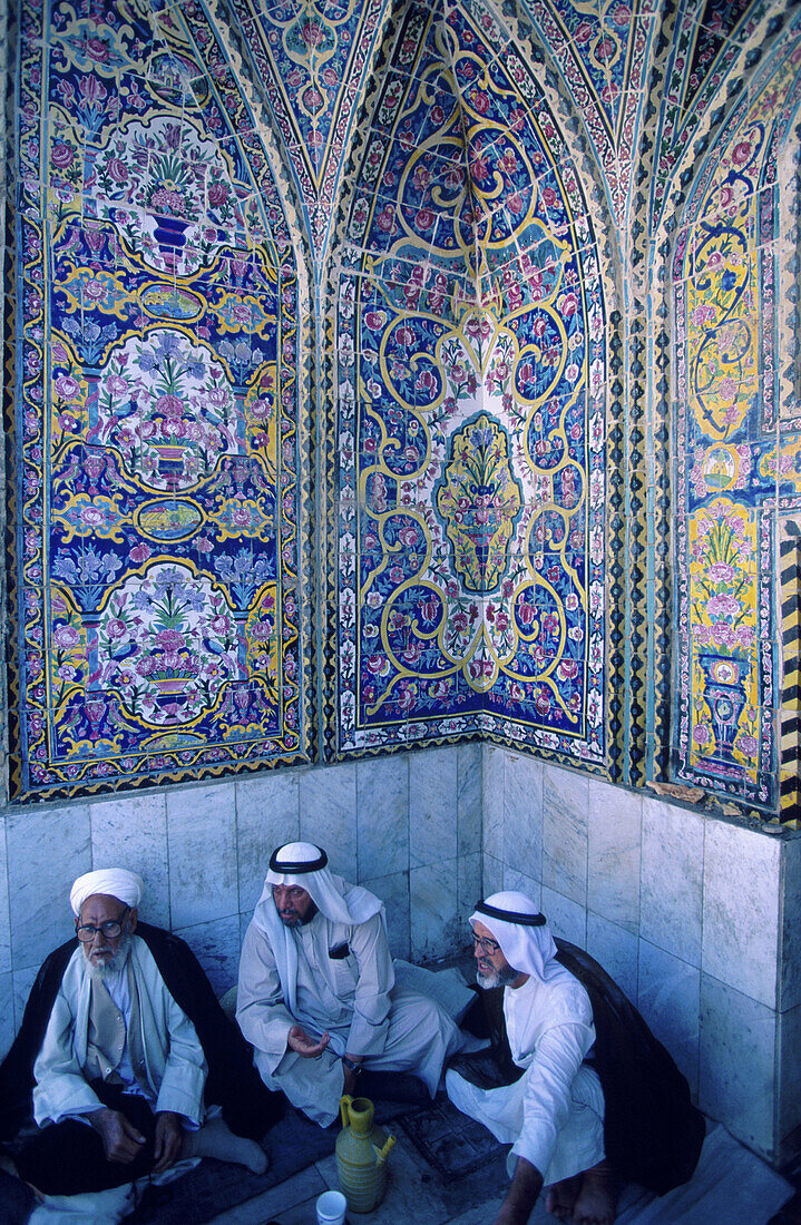 Men sat in the Sanctuary Mosque Al Kadhimain. Baghdad. Iraq