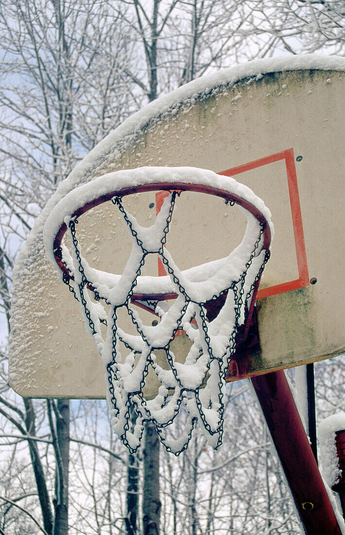 Snow on outdoor basketball hoop, Indiana, USA