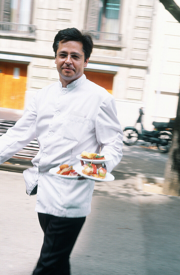 Spain, Catalunya, Barcelona. Tapas. Fast and smiling Waiter