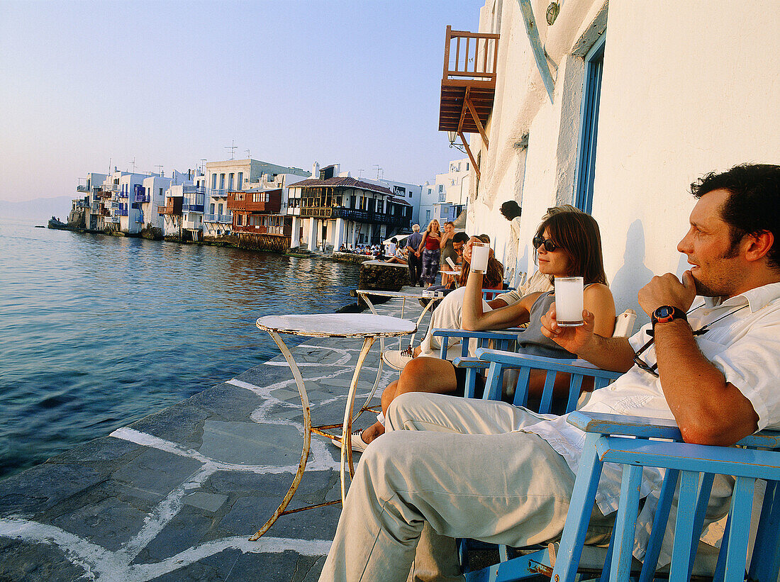 Greece, Cyclades Islands, Mykonos. Having a drink at sunset on little venice terraces