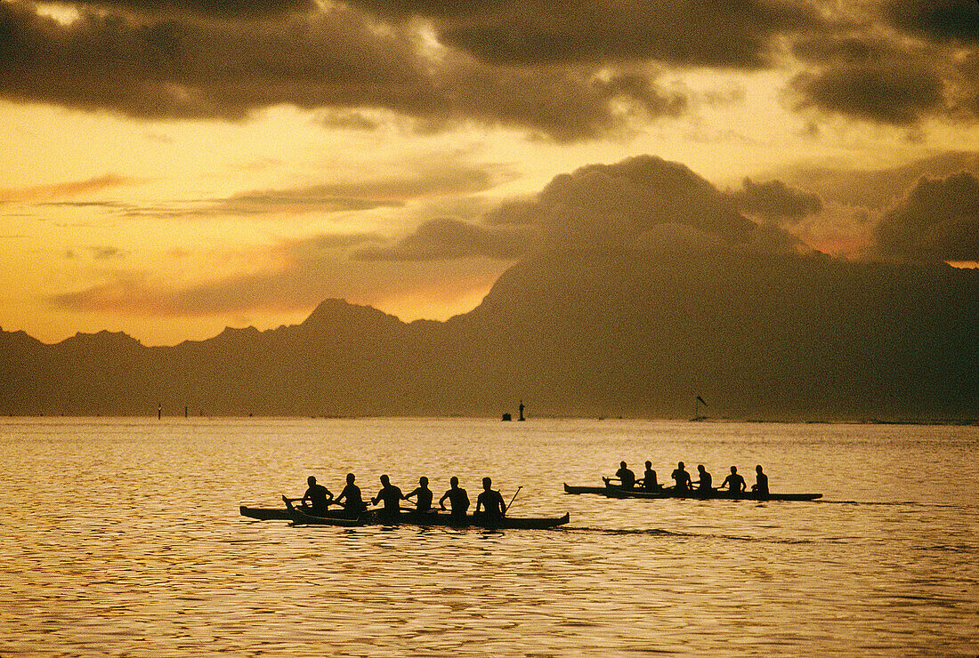 Training for the annual rowing contest, Moorea island in background. Papeete, Tahiti, French Polynesia