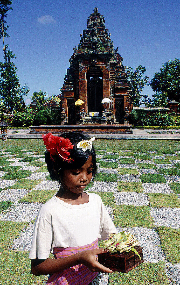 Young lady offering in a bouddhist ritual. Klungkung. Bali. Indonesia