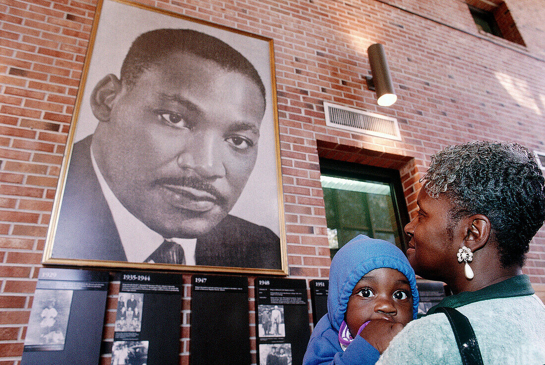 Grandmother with kid looking at Martin Luther King s portrait, in the Martin Luther King Foundation for Peace. Atlanta. Georgia. USA