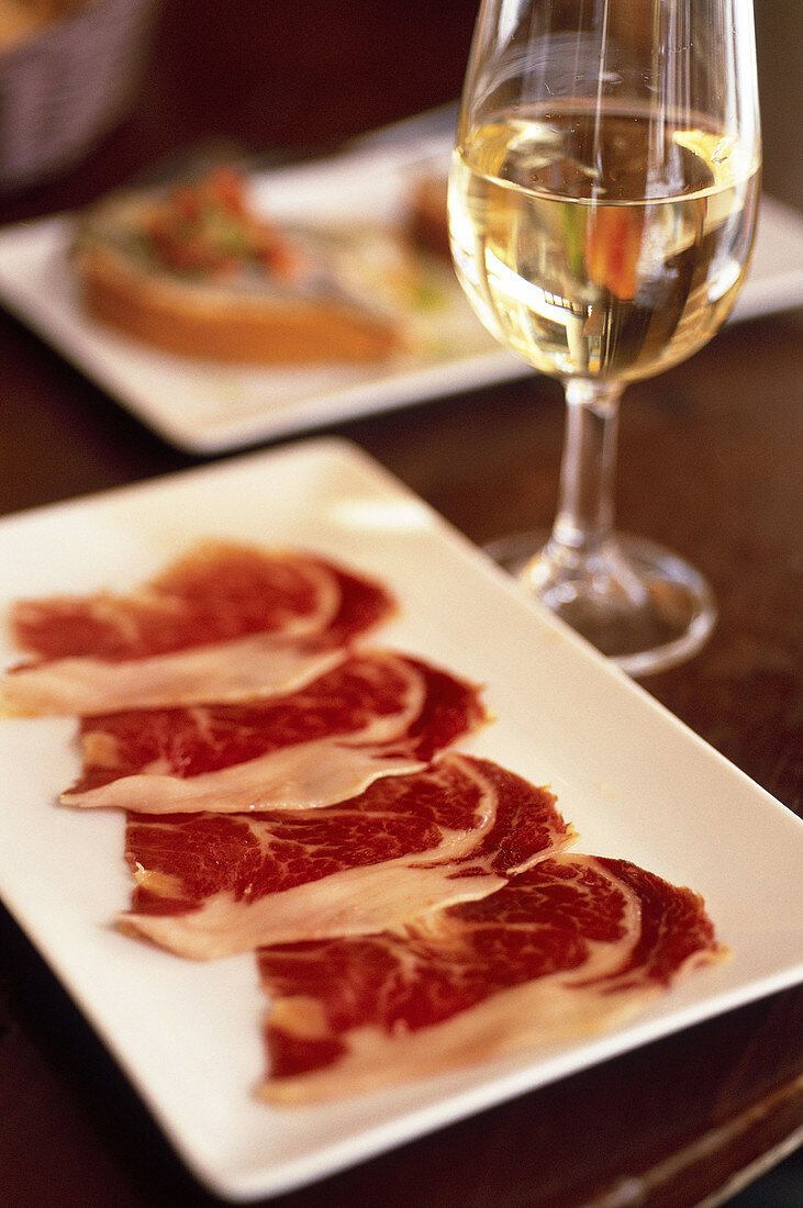 Spain. Andalusia. Jerez. Local cooking tapas. Slices of Jabugo ham pata negra and Sherry at the restaurant Gallo Azul