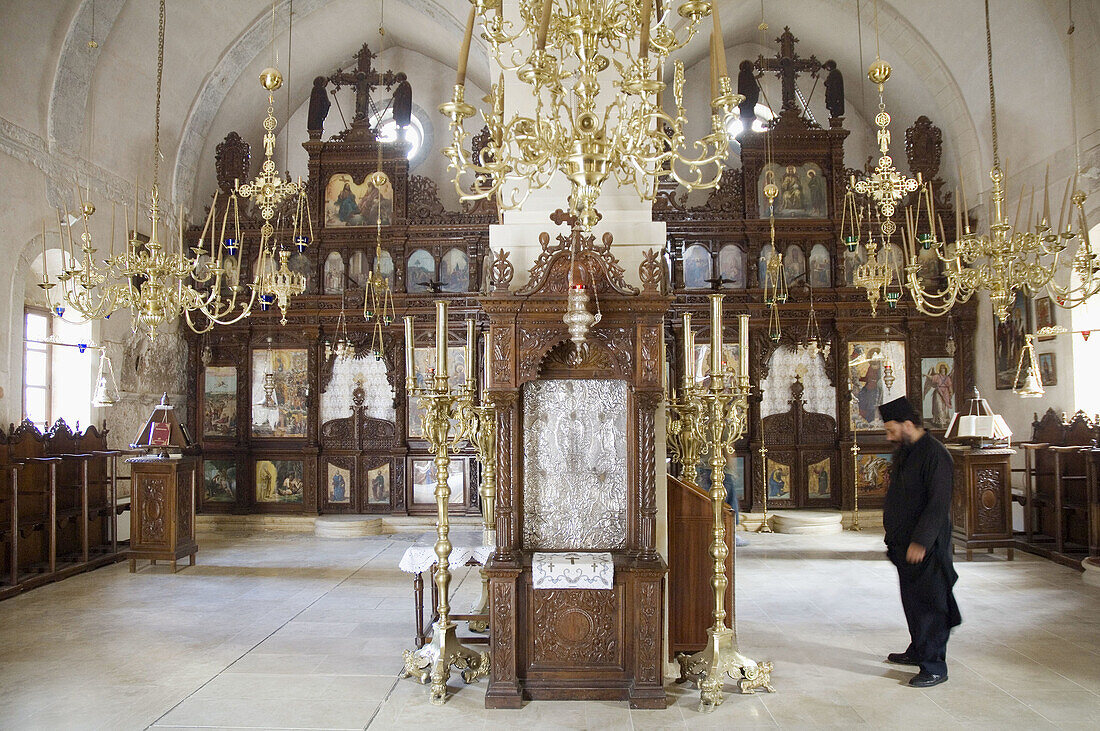 Arkadiou monastery with pope praying. Crete. Greece.