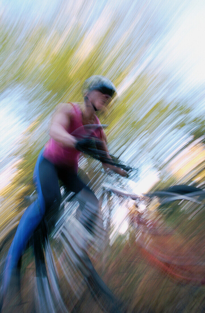ability, activity, adult, bicycle, bicyclist, biker, blurred motion, Color image, contemporary, cycle, cycling, day, effort, exercise, eye, Female, fit, full length, health, healthy, human, leisure, motion, mountain biking, moving, one, one person, outdoo