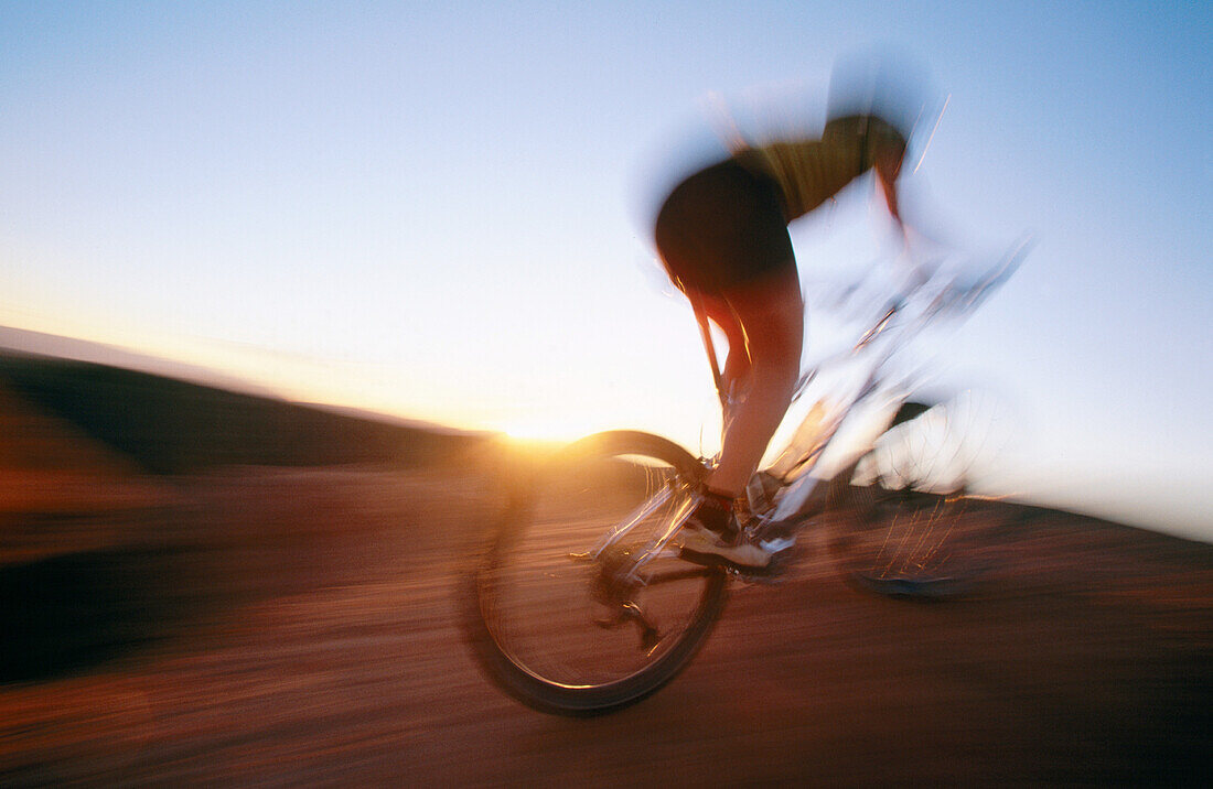 ability, activity, adult, bicycle, bicyclist, biker, blurred motion, Color image, contemporary, cycle, cycling, day, energy, exercise, fit, free, freedom, health, healthy, horizon, horizontal, human, leisure, Male, Man, Man only, motion, mountain biking, 