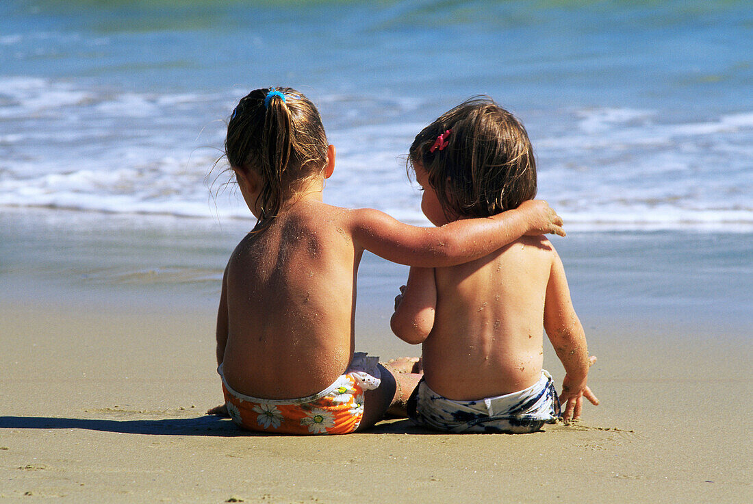 Two young girls together on the beach