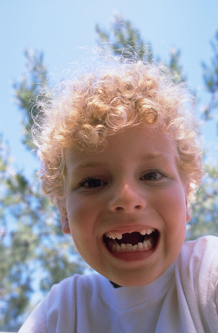 Young boy with toothless smile