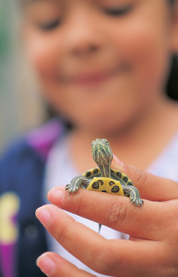 Young girl with pet turtle