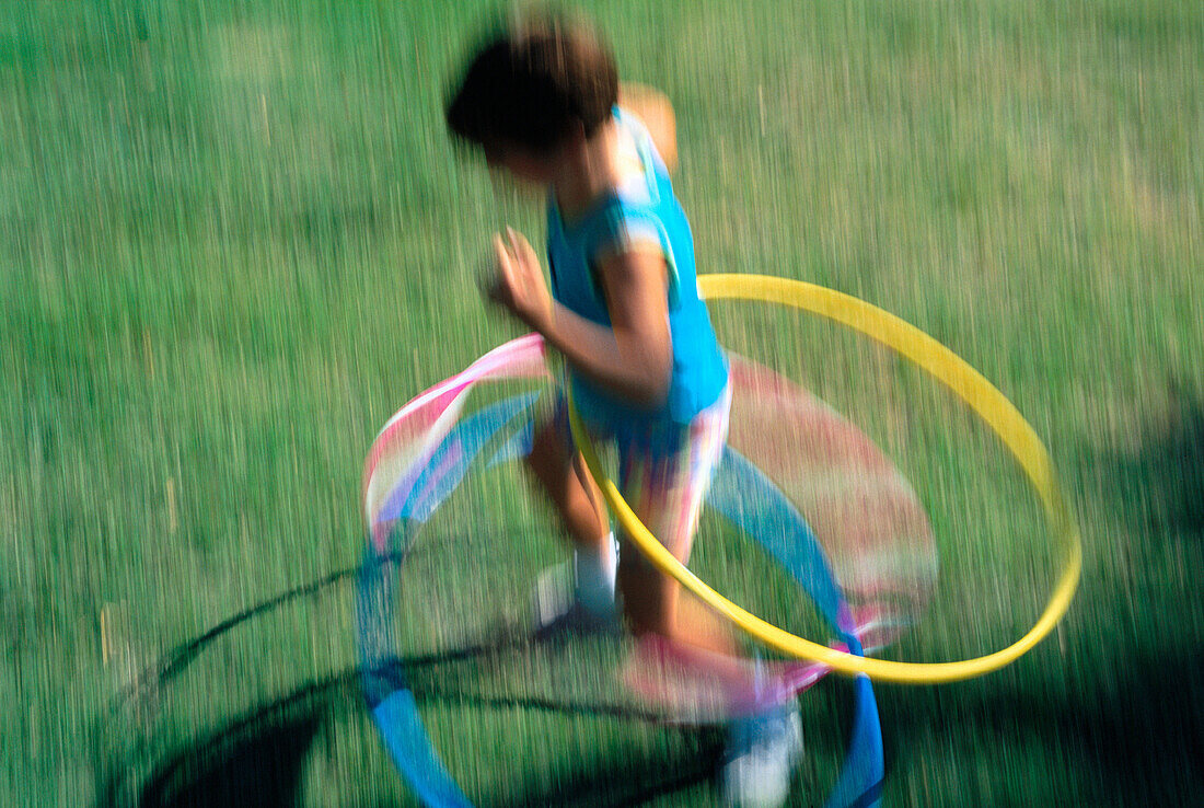 Girl playing with hula hoops