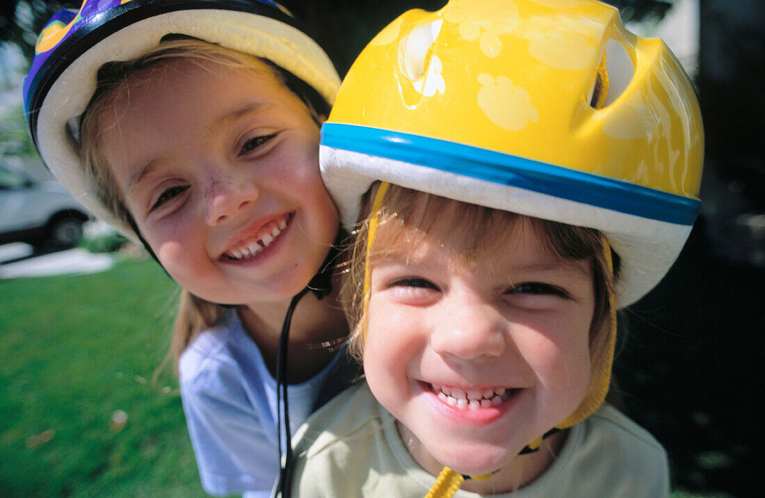 Friends together wearing bicycle helmets