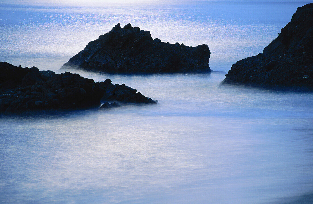 Ocean rocks under moonlight