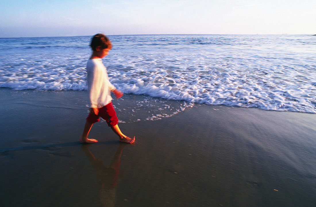 Boy walking on beach