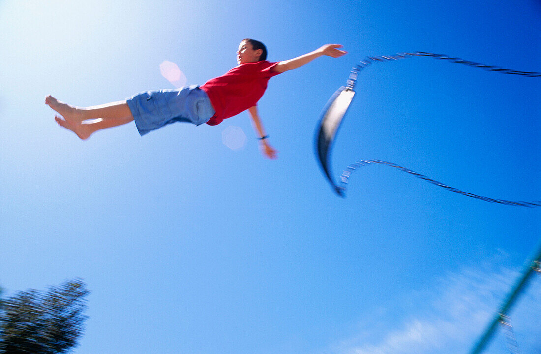 boy jumping from swing