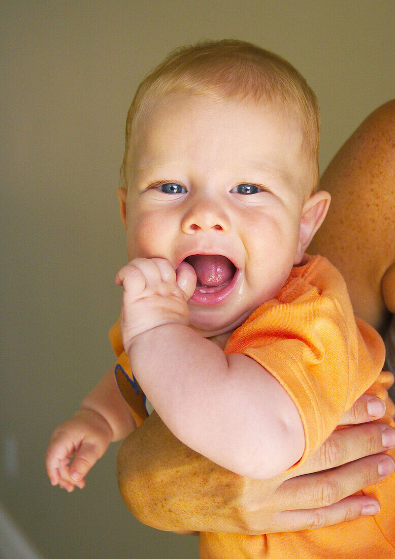 Mother holding happy baby