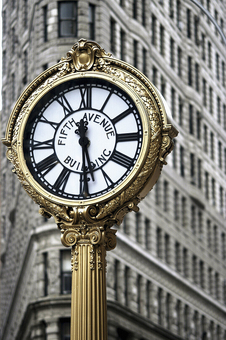 Clock with Flatiron Building in background. New York City. USA