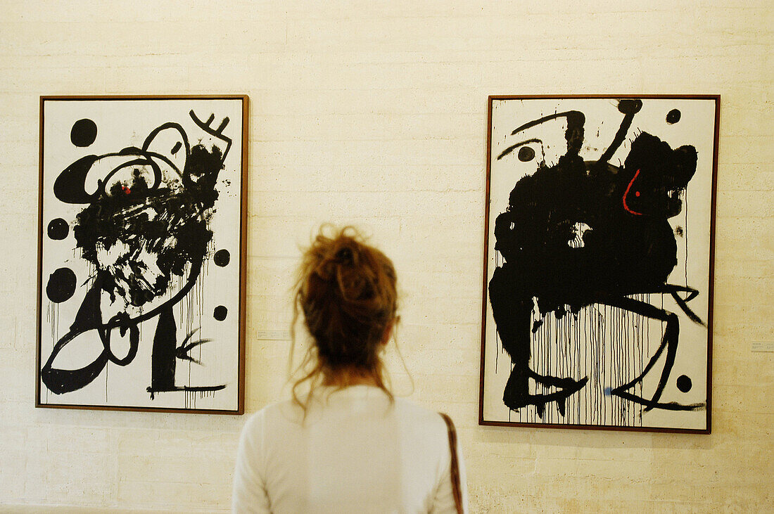 Woman looking to some Joan Miró paintings at Fundación Pilar i Joan Miro de Palma de Mallorca. Majorca. Balearic Islands. Spain