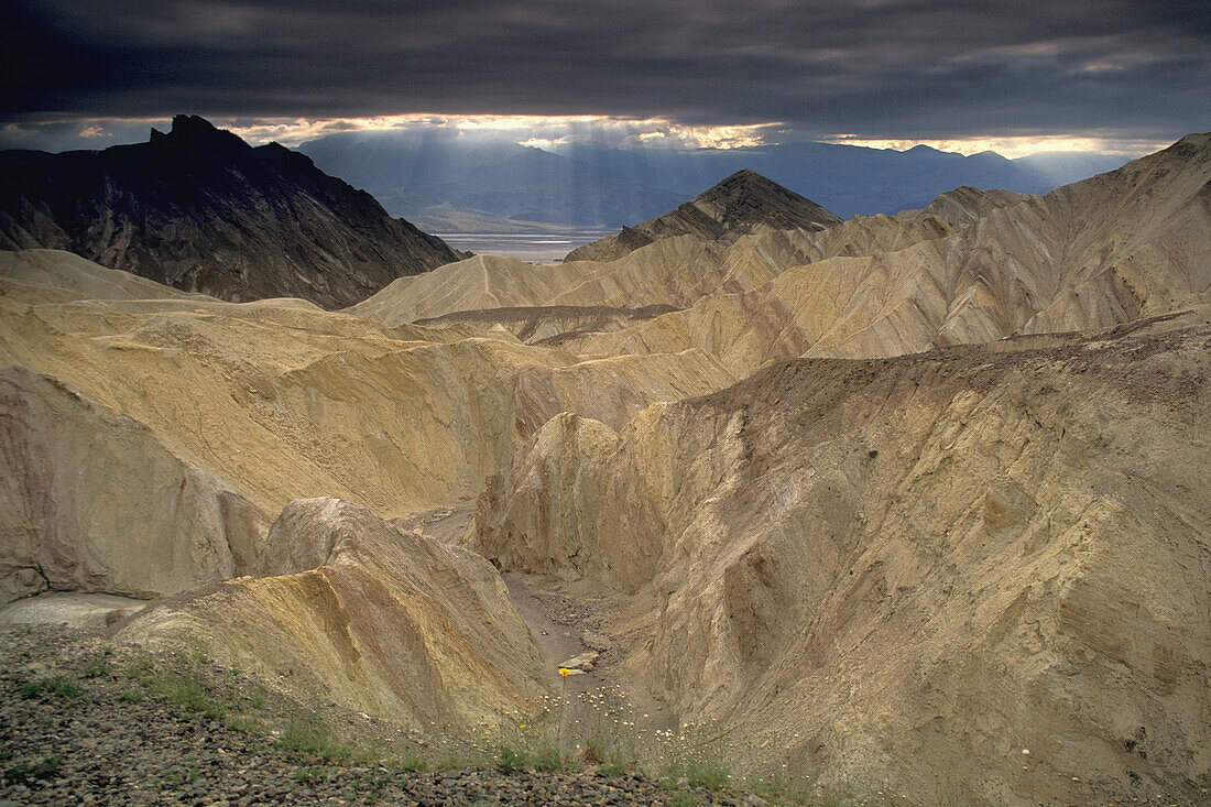 Storm clouds and sun beams over Golden Canyon, Death Valley National Park, California