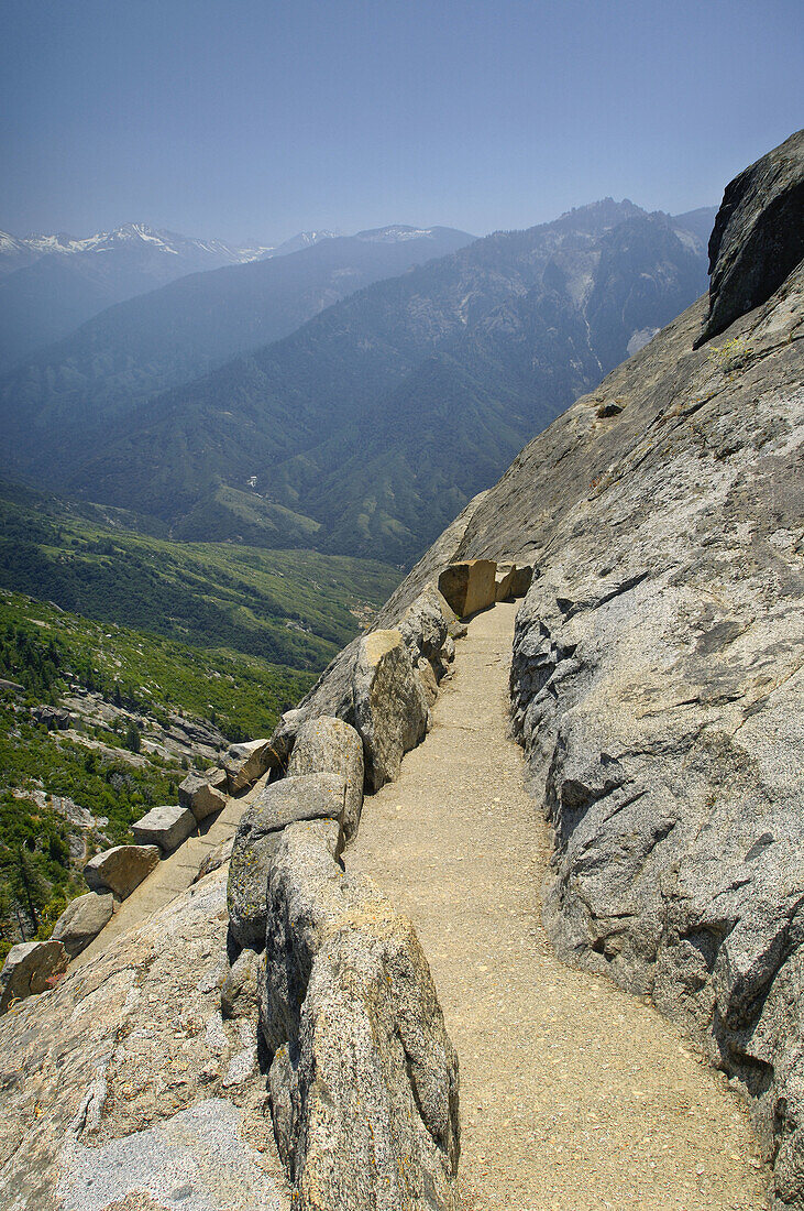 View of the High Sierra mountain peaks and forest from hiking trail to the top of Moro Rock, Sequoia National Park, California
