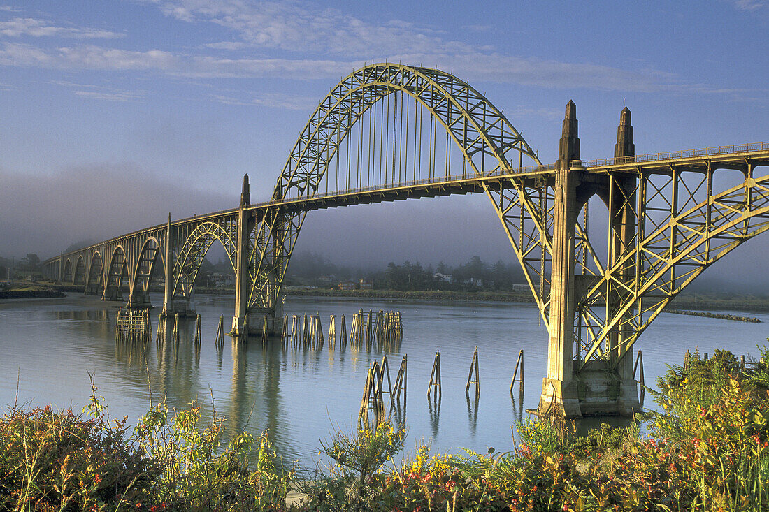 Sunrise light on the Yaquina Bay Bridge and fog over Yaquina Bay, Newport, Oregon Coast