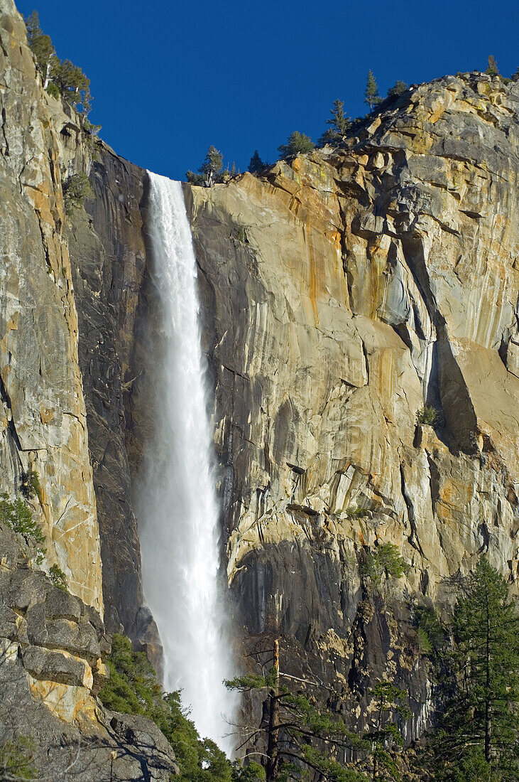 Water rushing over stone cliff in spring, Bridalveil Fall, Yosemite Valley, Yosemite National Park, California