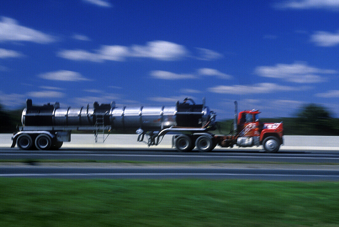  Blurred, Color, Colour, Daytime, Economy, Exterior, Fast, Freight transportation, Highway, Highways, Industrial, Industry, Lorries, Lorry, Motion, Movement, Moving, Outdoor, Outdoors, Outside, Road, Road tanker, Road tankers, Roads, Shipping, Speed, Thor