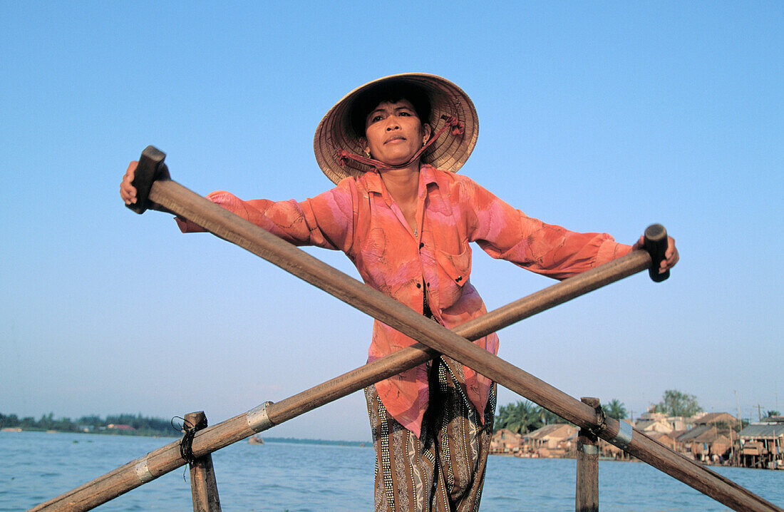 Rower in traditional riverboat. Cantho. Vietnam