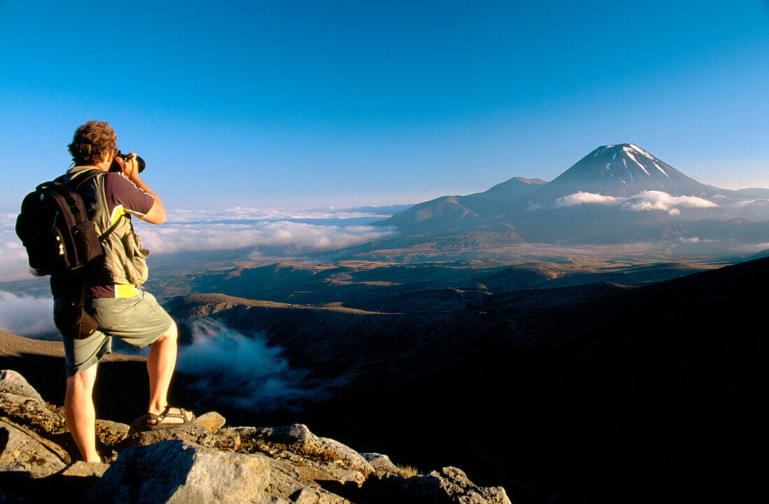 Photographer and Mt. Ngauruhoe. Tongariro National Park, Central Plateau. North Island. New Zealand