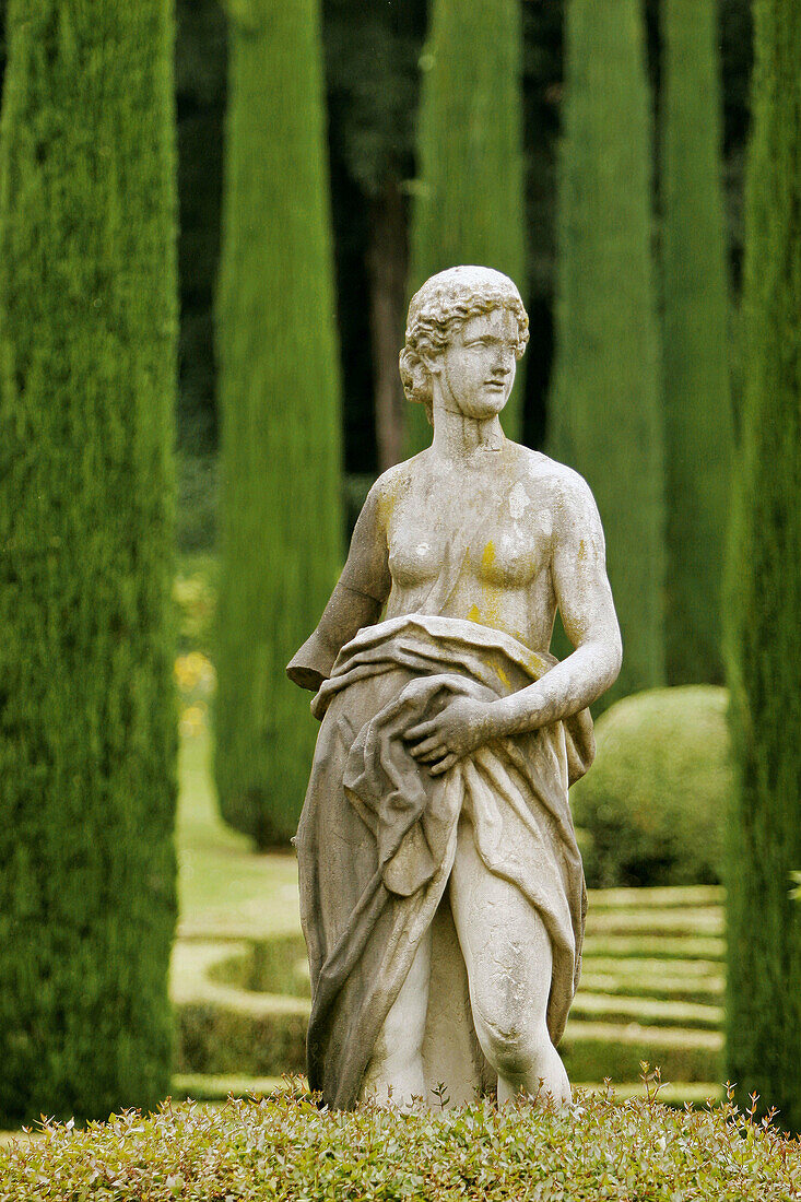 Renaissance marble statue surrounded by cypress trees in the Giardino Giusti, Verona, Italy