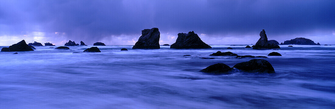 Approaching storm clouds at Face Rock State Park, dusk. Bandon. Oregon. USA