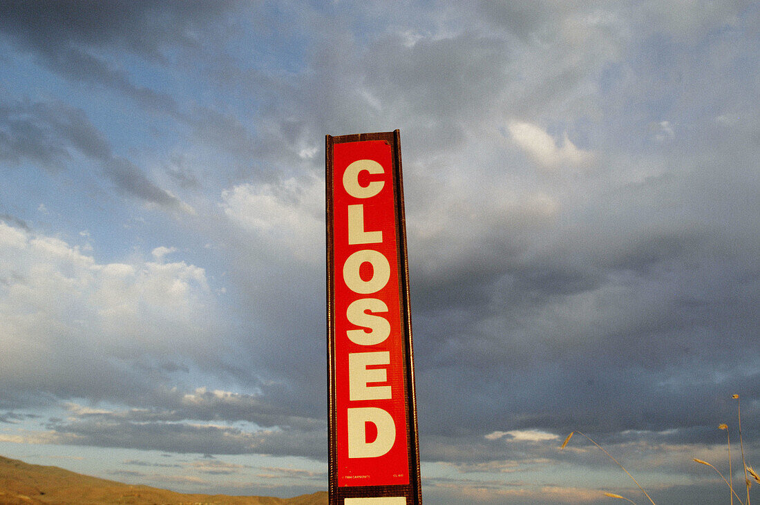 Closed sign and clouds