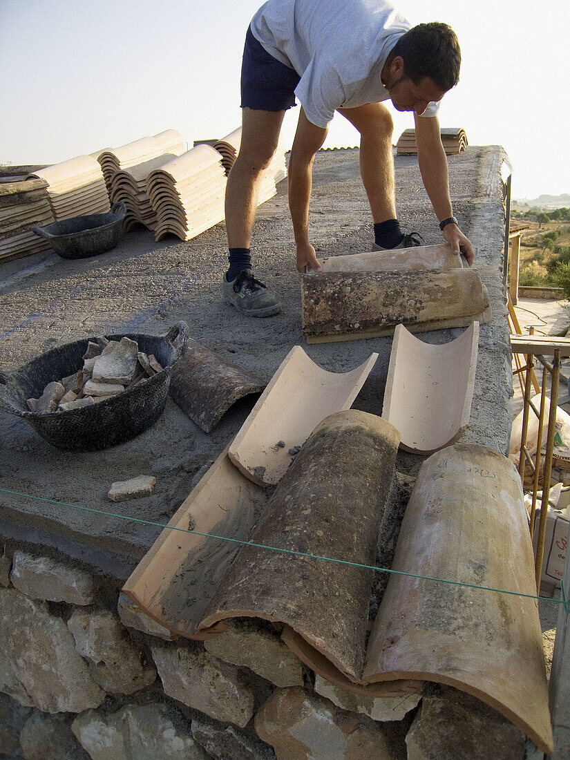 Fixing a roof with traditional tiles. Mallorca. Balearic Islands. Spain.