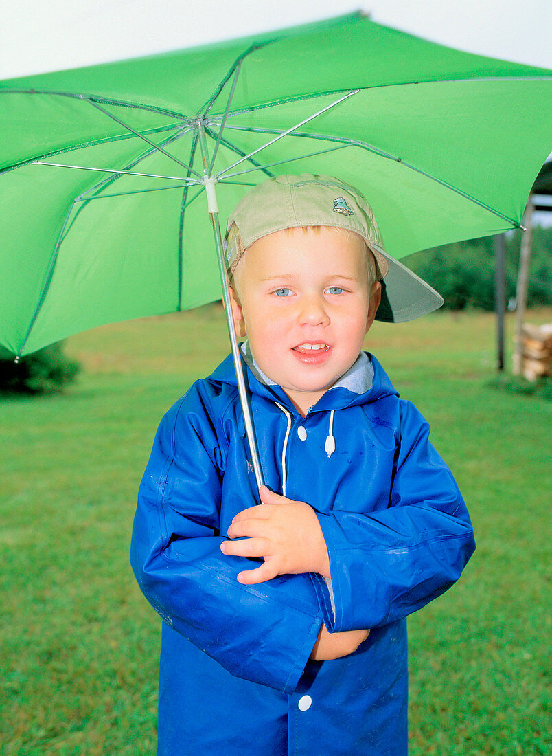 3 years old boy with an umbrella. Västerbotten, Sweden
