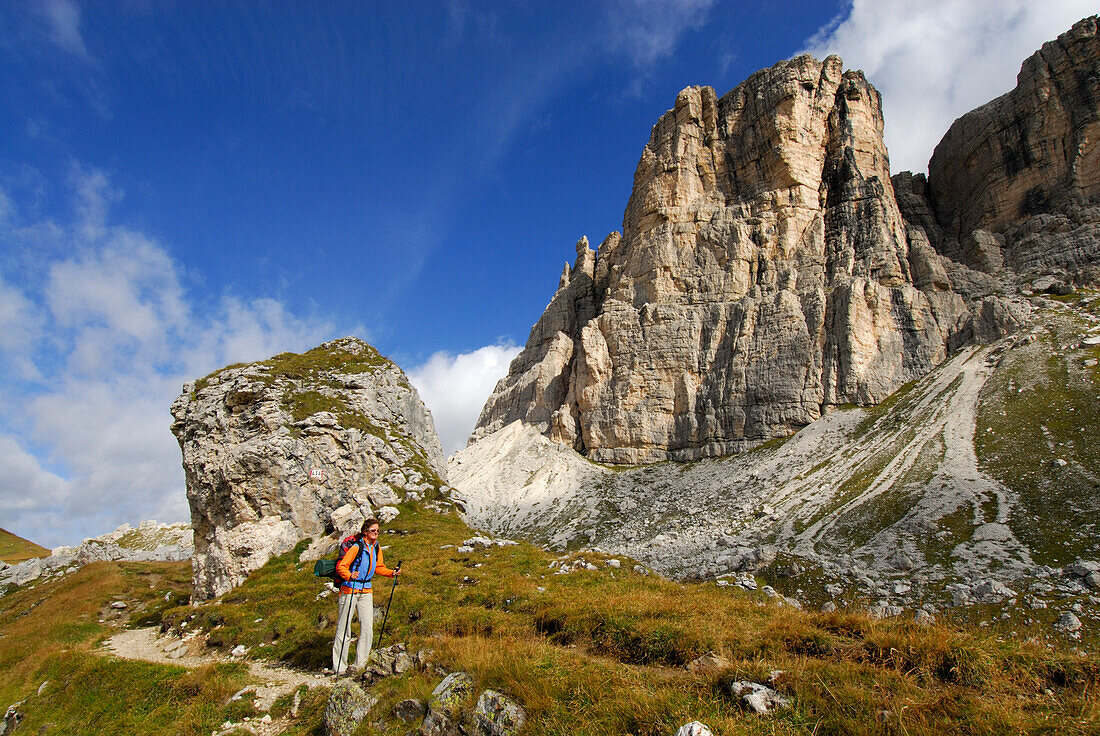 Young woman beneath south wall of Monte Formin, Alta Via delle Dolomiti No. 1, Dolomites, Cortina, Venezia, Italy