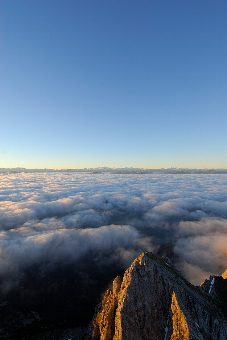 Mountain Kaiserkopf above fog bank, Hohe Tauern range in background, Ellmauer Halt, Kaiser range, Tyrol, Austria