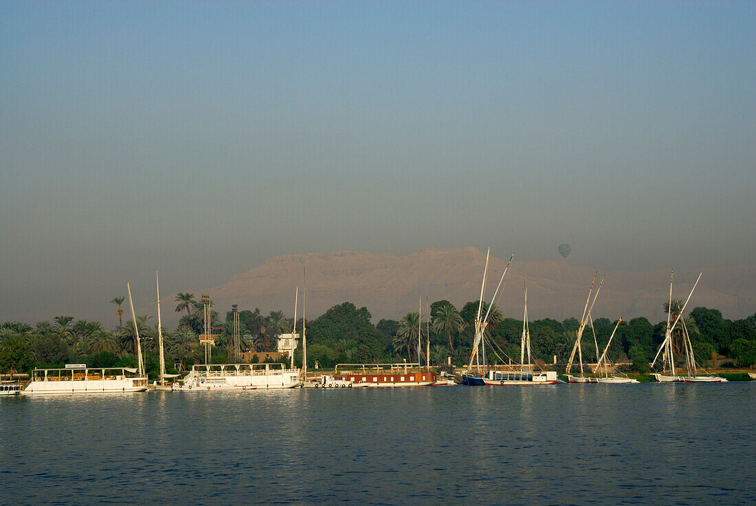cruise on the Nile, view from upper deck to boats at western bank, Nile between Luxor and Dendera, Egypt, Africa