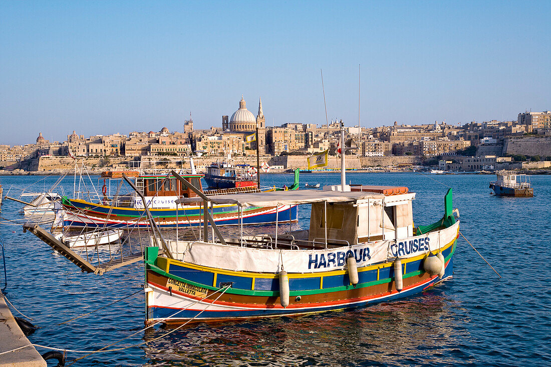 Colourful excursion boat at Marsamxett Harbour with view at  the town Valletta, Sliema, Malta, Europe