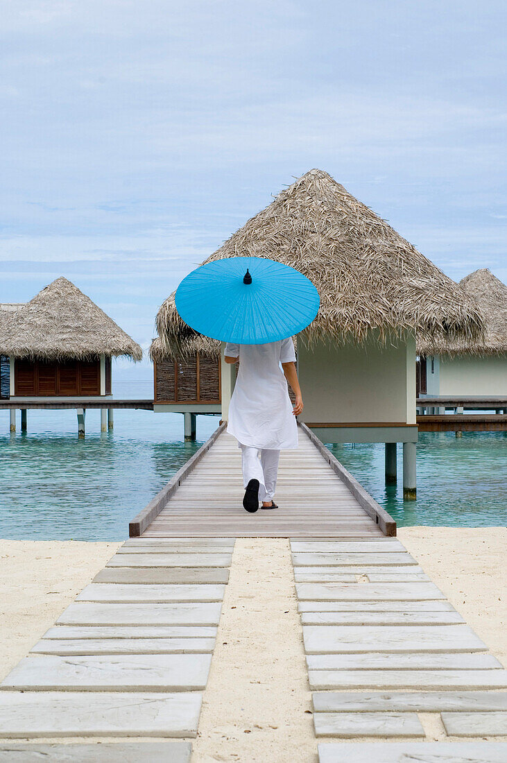 Woman, Spa therapist with parasol, Spa Pavilions, Four Seasons Resort Landaa Giraavaru, Maldives