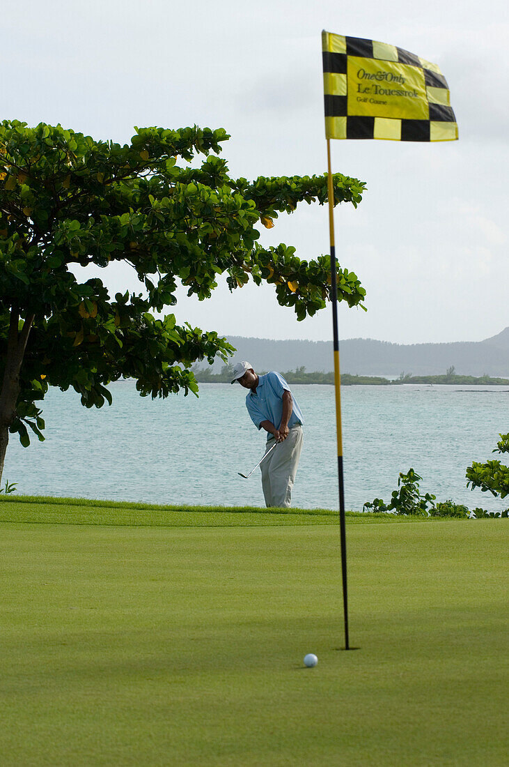 Man playing golf, One & Only Le Touessrok Golf course, Bernhard Langer Design, Mauritius