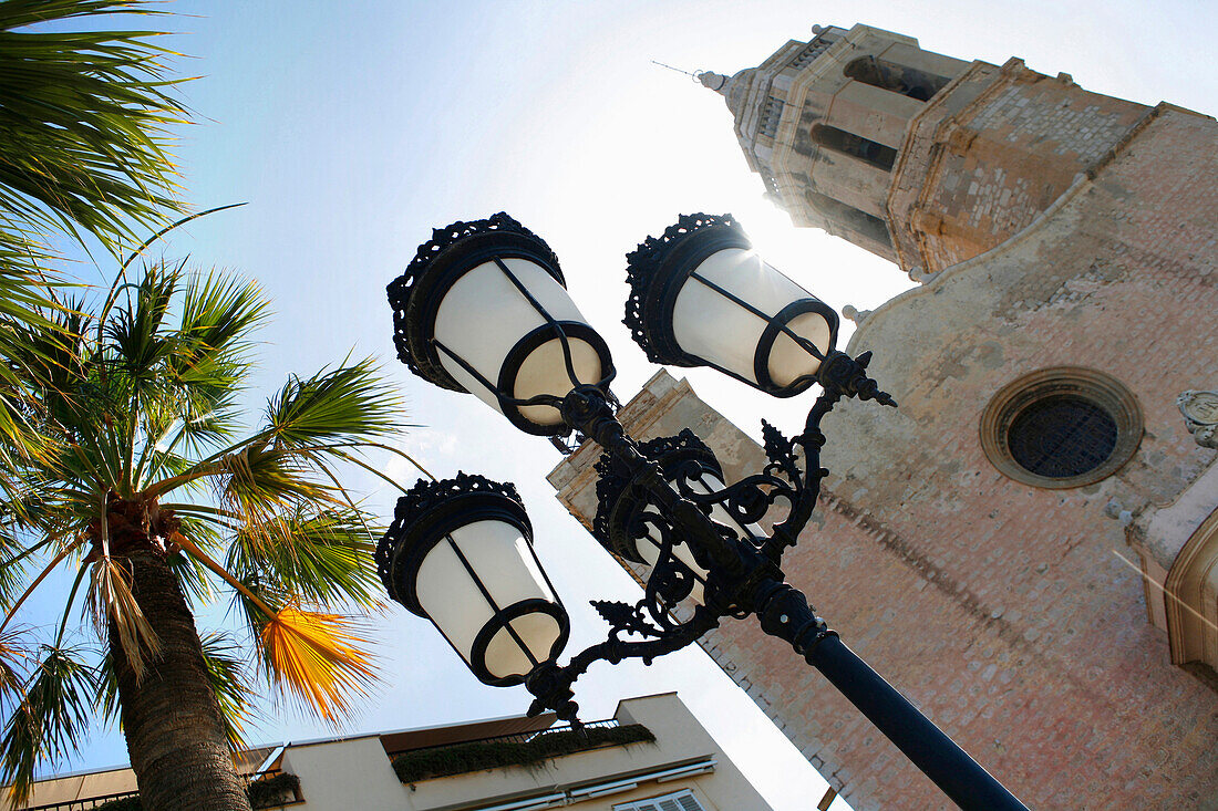 A streetlamp in front of a church, Sitges, Catalonia, Spain