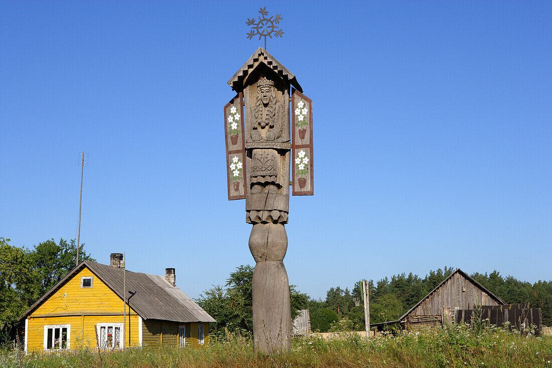 Carved wooden pole decorates farmhouses in the district of Druskininkai, Lithuania
