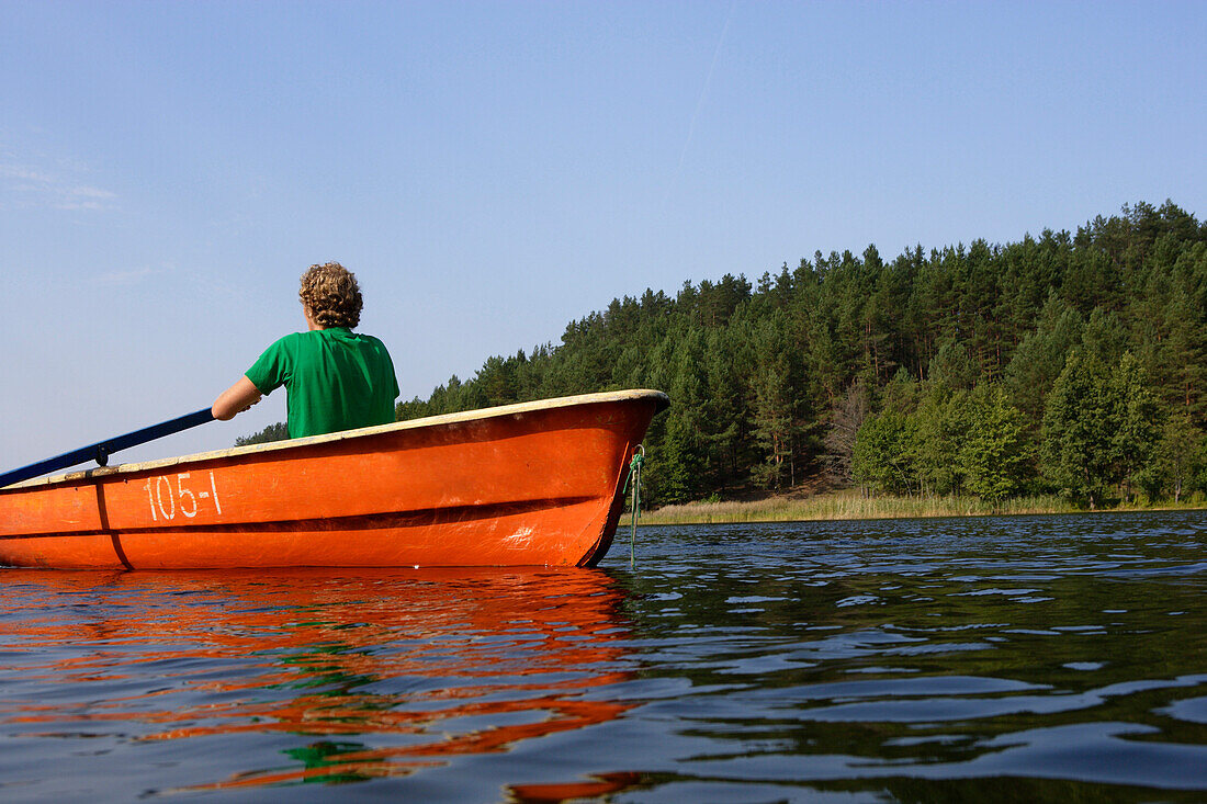 Man rowing a boat on Lake Lusis in Paluse, Aukstaitija National Park, Lithuania