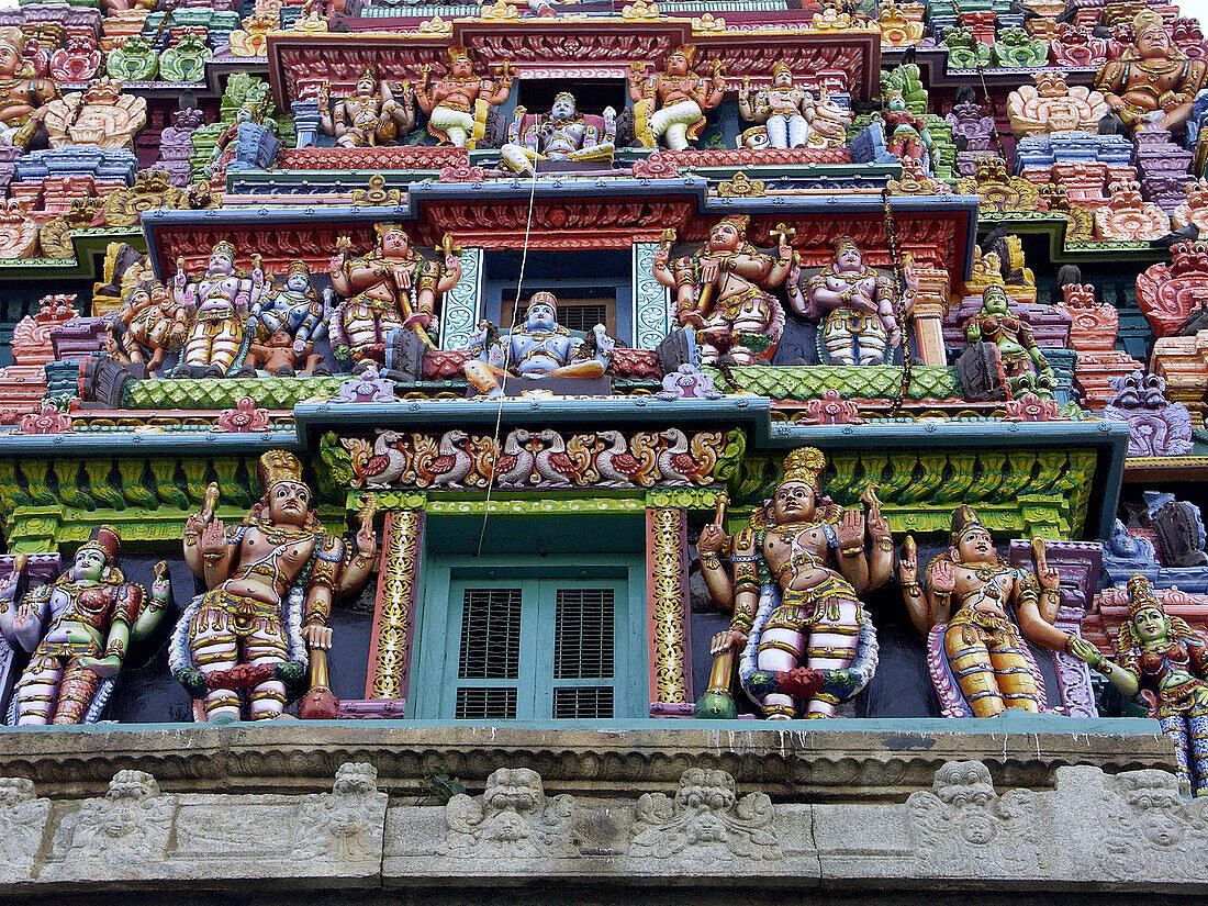 Hindu dieties on tower at entrance to Hindu temple in Bangalore. Karnataka, India 