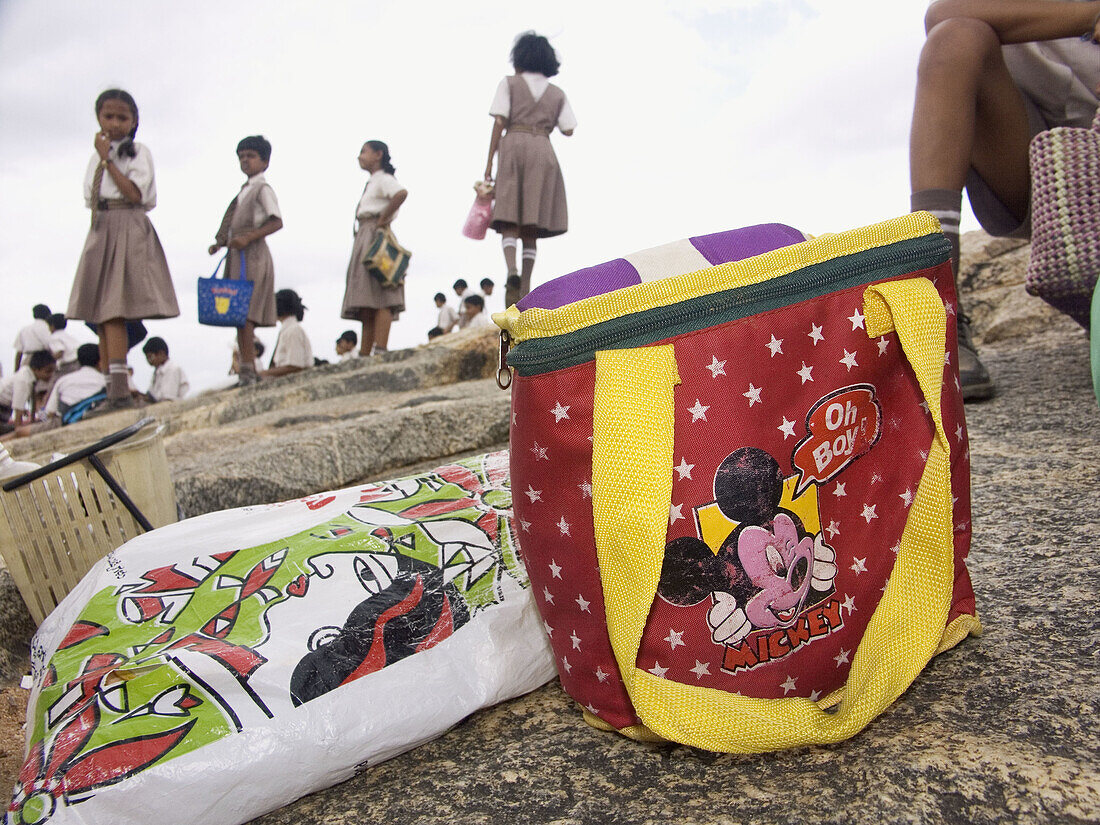 School girls and their lunchbags (with Indian and American icons) at Lal Bagh, a park, in Bangalore, India
