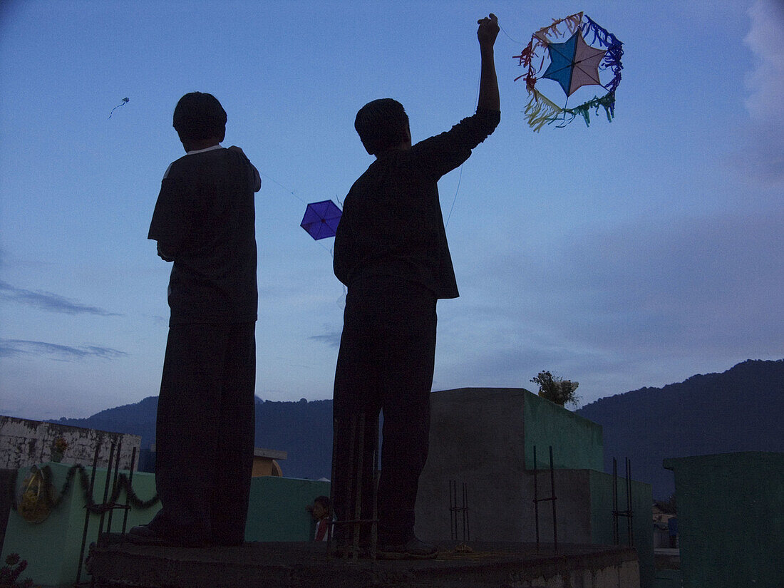 Kids fly kites on Day of the Dead in San Lucas Toliman, Guatemala, near Lake Atitlan